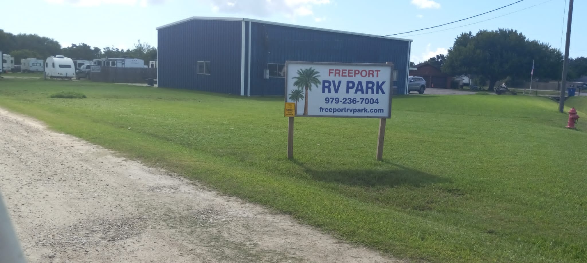Freeport RV Park — entrance sign and blue office building
